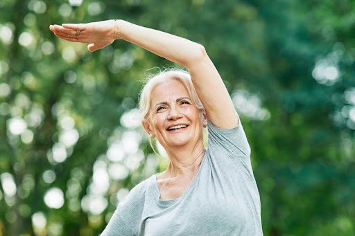 Joyful woman stretching outdoors, radiating wellness and energy